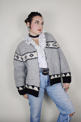vintage 1970's long sleeve wool zip up cowichan cardigan in grey, white, and black with a deer design on the back