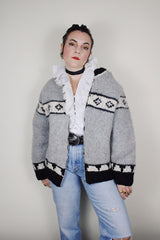 vintage 1970's long sleeve wool zip up cowichan cardigan in grey, white, and black with a deer design on the back