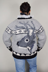vintage 1970's long sleeve wool zip up cowichan cardigan in grey, white, and black with a deer design on the back