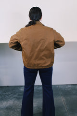 Women's or men's vintage 1980's Sir Jac label long sleeve brown Nylon zip up windbreaker jacket with cotton liner, pockets, and a pointy collar.