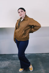 Women's or men's vintage 1980's Sir Jac label long sleeve brown Nylon zip up windbreaker jacket with cotton liner, pockets, and a pointy collar.