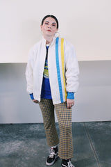 Men's or women's vintage 1970's long sleeve white nylon material zip up windbreaker jacket with a yellow and blue strip on one side. Has patches, pockets, and faux fur body liner.