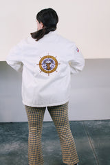 Men's or women's vintage 1970's long sleeve white nylon material zip up windbreaker jacket with a yellow and blue strip on one side. Has patches, pockets, and faux fur body liner.