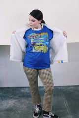 Men's or women's vintage 1970's long sleeve white nylon material zip up windbreaker jacket with a yellow and blue strip on one side. Has patches, pockets, and faux fur body liner.