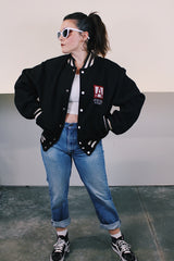 Men's vintage 1970's Empire Sporting Goods, New York, Union Made label long sleeve black wool bomber jacket with white popper buttons and white striped trim. 1979 Jethro Tull in Concert jacket.