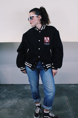 Men's vintage 1970's Empire Sporting Goods, New York, Union Made label long sleeve black wool bomber jacket with white popper buttons and white striped trim. 1979 Jethro Tull in Concert jacket.