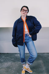 Men's vintage 1980's Topps Safety Apparel Inc., Made in USA label long sleeve navy blue cotton zip up station jacket with three front pockets and collar.