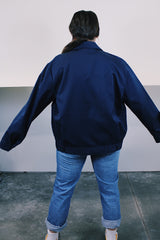 Men's vintage 1980's Topps Safety Apparel Inc., Made in USA label long sleeve navy blue cotton zip up station jacket with three front pockets and collar.