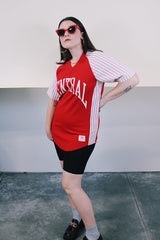 Women's or men's vintage 1970's Champion Products Inc. label short sleeve red and white colored Nylon material sports jersey with V shaped neckline and text on front and back.