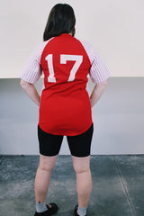 Women's or men's vintage 1970's Champion Products Inc. label short sleeve red and white colored Nylon material sports jersey with V shaped neckline and text on front and back.