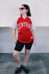 Women's or men's vintage 1970's Champion Products Inc. label short sleeve red and white colored Nylon material sports jersey with V shaped neckline and text on front and back.