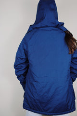 vintage 1980's Woolrich, Made in USA label long sleeve dark blue zip up parka jacket with removable hood, four front velcro pockets, and brass popper buttons