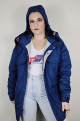 vintage 1980's Woolrich, Made in USA label long sleeve dark blue zip up parka jacket with removable hood, four front velcro pockets, and brass popper buttons