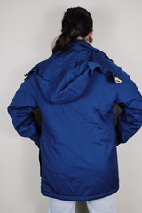 vintage 1980's Woolrich, Made in USA label long sleeve dark blue zip up parka jacket with removable hood, four front velcro pockets, and brass popper buttons