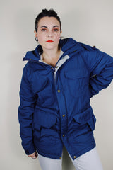 vintage 1980's Woolrich, Made in USA label long sleeve dark blue zip up parka jacket with removable hood, four front velcro pockets, and brass popper buttons