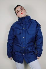 vintage 1980's Woolrich, Made in USA label long sleeve dark blue zip up parka jacket with removable hood, four front velcro pockets, and brass popper buttons