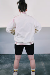 Men's or women's vintage 1970's Swingster, Made in USA label long sleeve cream colored zip bomber jacket. Lightweight polyester and cotton material. Red striped and trim, red Coca Cola embroidery.