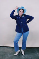 Women's vintage western style 1970's California Ranchwear label long sleeve navy blue blouse with pointy collar and pearly blue popper buttons. Has floral embroidery on shoulders.