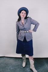 Women's vintage 1950's Jack Frost Woolen Wear, The Original Utah Woolen Mills, Salt Lake City label long sleeve grey colored button up blazer with double lapel, two pockets, and fabric covered buttons.