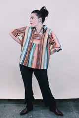 Women's vintage western style 1980's short sleeve pullover blouse in green, peach, and brown vertical striped patterns. Collar and V shaped neckline.
