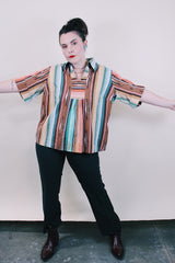 Women's vintage western style 1980's short sleeve pullover blouse in green, peach, and brown vertical striped patterns. Collar and V shaped neckline.