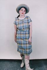 Women's vintage western style 1960's short sleeve midi length plaid print shift dress with white scalloped trim. Grey, teal, and mustard yellow colors.
