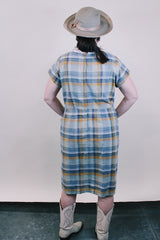 Women's vintage western style 1960's short sleeve midi length plaid print shift dress with white scalloped trim. Grey, teal, and mustard yellow colors.