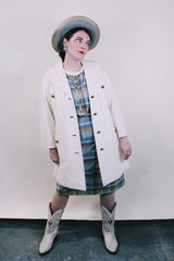 Women's vintage 1960's Lilli Ann, Paris & San Francisco label 3/4 arm length long length cream colored vinyl polyester coat with big round gold buttons and four front pockets