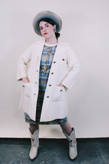 Women's vintage 1960's Lilli Ann, Paris & San Francisco label 3/4 arm length long length cream colored vinyl polyester coat with big round gold buttons and four front pockets