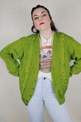 vintage 1960's SKM Penguin, Seattle Knitting Mills label long sleeve green button up wool cardigan with braiding detail on each side and tan leather patches on the elbows