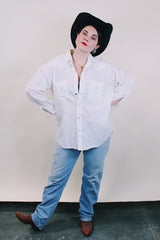 Women's or men's western style vintage 1970's Ely Plains, Since 1978 label long sleeve white button up shirt with pockets, collar, and pearl snapper buttons.