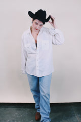 Women's or men's western style vintage 1970's Ely Plains, Since 1978 label long sleeve white button up shirt with pockets, collar, and pearl snapper buttons.