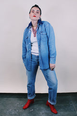 Women's or men's vintage 1980's Wrangler, Preshrunk, X-Long Tails, Made in USA label long sleeve medium wash denim Wrangler western style button up shirt with pearl popper buttons.