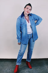 Women's or men's vintage 1980's Wrangler, Preshrunk, X-Long Tails, Made in USA label long sleeve medium wash denim Wrangler western style button up shirt with pearl popper buttons.