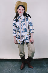 Women's or men's western style vintage 1970's Spire California label long sleeve white polyester button up collared shirt with an all over brown, yellow, and grey belt print.