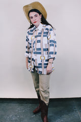 Women's or men's western style vintage 1970's Spire California label long sleeve white polyester button up collared shirt with an all over brown, yellow, and grey belt print.