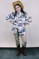 Women's or men's western style vintage 1970's Spire California label long sleeve white polyester button up collared shirt with an all over brown, yellow, and grey belt print.