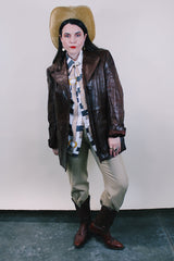 Men's or Women's western style vintage 1980's Fantastic International, Fashions From The World label long sleeve chocolate brown leather button up jacket with pointy double lapel and pockets.