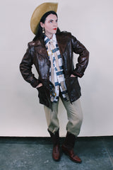 Men's or Women's western style vintage 1980's Fantastic International, Fashions From The World label long sleeve chocolate brown leather button up jacket with pointy double lapel and pockets.