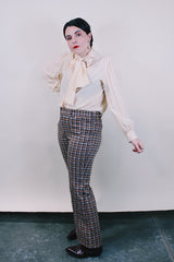 Women's or men's vintage western style 1970's polyester material brown plaid pants in chocolate brown, tan, and white. Four pockets, belt loops, and zipper closure with slight bell bottoms.