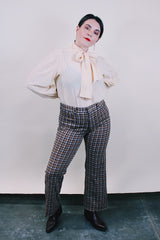 Women's or men's vintage western style 1970's polyester material brown plaid pants in chocolate brown, tan, and white. Four pockets, belt loops, and zipper closure with slight bell bottoms.