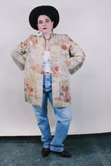 Women's vintage 1960's long sleeve and long length gold colored silk robe kimono with all over multicolored embroidered floral design. Pockets, mandarin collar and fabric covered buttons