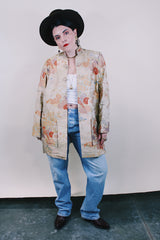 Women's vintage 1960's long sleeve and long length gold colored silk robe kimono with all over multicolored embroidered floral design. Pockets, mandarin collar and fabric covered buttons