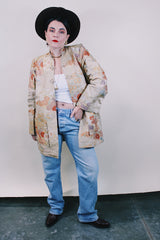 Women's vintage 1960's long sleeve and long length gold colored silk robe kimono with all over multicolored embroidered floral design. Pockets, mandarin collar and fabric covered buttons