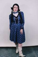 Women's vintage western style 1970's Candi Jones California label long sleeve midi length prairie dress in navy cotton material with all over ditsy floral print.