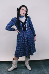 Women's vintage western style 1970's Candi Jones California label long sleeve midi length prairie dress in navy cotton material with all over ditsy floral print.
