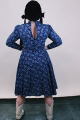 Women's vintage western style 1970's Candi Jones California label long sleeve midi length prairie dress in navy cotton material with all over ditsy floral print.