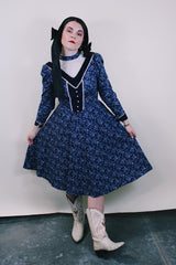 Women's vintage western style 1970's Candi Jones California label long sleeve midi length prairie dress in navy cotton material with all over ditsy floral print.