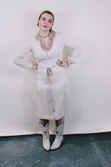 Women's vintage 1970's Keith Adams For Tannel label long sleeve midi length cream tan colored tunic dress with embroidered neckline with bead and a tassel beaded belt.