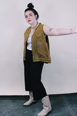 Men's vintage 1950's Bullseye Bill label sleeveless brownish green hunting vest with brass rapid zipper, multiple pockets and compartments and wide arm holes.